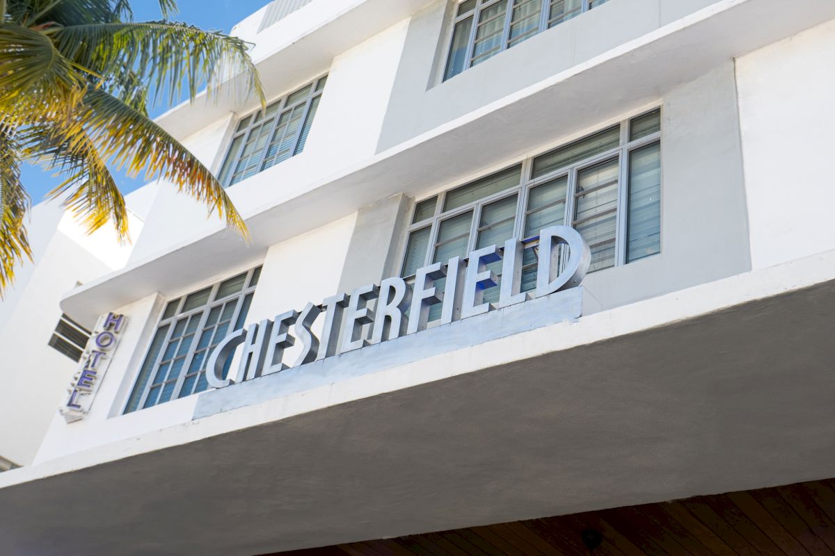 A white building with the word 'CHESTERFIELD' in large letters on the front facade, with a palm tree to the left.